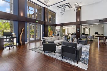 A modern living room with a large rug and a long couch.
