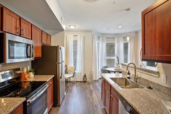 A kitchen with granite counter tops and stainless steel appliances