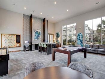 A large living room with a pool table