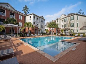 The Woodlands apartment for rent - a large swimming pool in front of an apartment building  at Volare at the Woodlands, The Woodlands, Texas