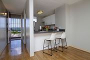 Waipahu apartment for rent - a view of a kitchen with two stools in front of a bar with chairs at Waikele Towers Apartments, Waipahu, HI