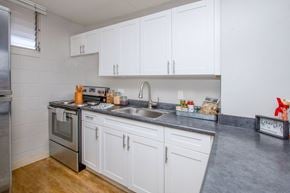 Waipahu apartment for rent - a kitchen with white cabinets and stainless steel appliances and a sink at Waikele Towers Apartments, Waipahu, Hawaii