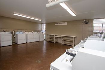 Laundry room filled with washers and dryers and sinks