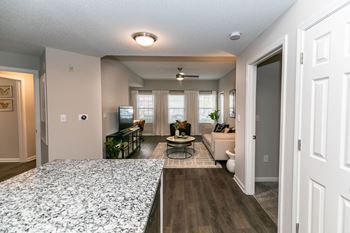 An open kitchen and living room with a couch and a table