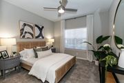 Atlanta apartment for rent - a bedroom with a large bed and a ceiling fan at Willowest in Lindbergh, Georgia