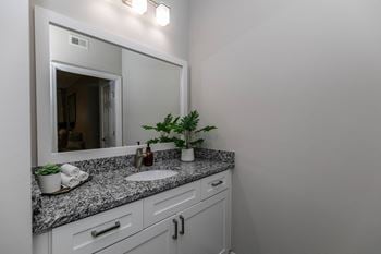 A bathroom with a sink and a mirror