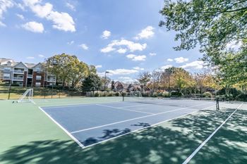 Tennis courts with apartment buildings in the background
