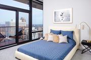 Minneapolis apartment for rent - Spacious Bedrooms with a large bed and a view of the city at 365 Nicollet, Manchester
