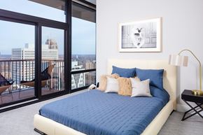 Minneapolis apartment for rent - Spacious Bedrooms with a large bed and a view of the city at 365 Nicollet, Manchester