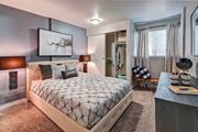 Edmonds apartment for rent - A bedroom with a large bed with a grey quilted duvet cover and a painting on the wall at Brackett Apartments, Edmonds, 98020