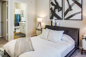 Cypress apartment for rent - a bedroom with a large bed and a bathroom at Carrington at Barker Cypress, Texas