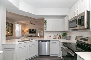 Alpharetta apartment for rent - a kitchen with white cabinets and stainless steel appliances at Deerfield Village, Georgia