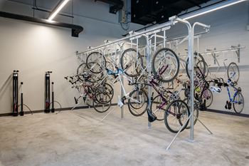 A bike rack with many bikes hanging on it.