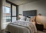 Chicago apartment for rent - A bedroom with a large bed and a window with curtains. at The Mason Apartments, Chicago, Illinois