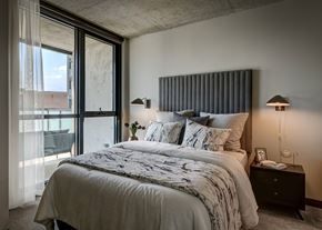 Chicago apartment for rent - A bedroom with a large bed and a window with curtains. at The Mason Apartments, Chicago, Illinois