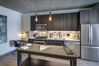 A modern kitchen with a dining table and chairs.
