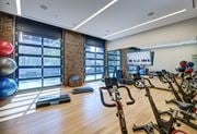 Chicago apartment for rent - A gym with a brick wall and wooden floors. at The Mason Apartments, Chicago, IL