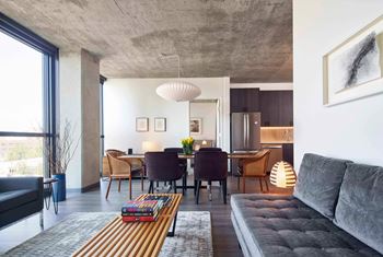 A modern living room with a grey sofa and a wooden coffee table.