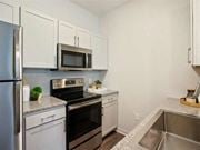 The Woodlands apartment for rent - a kitchen with stainless steel appliances and white cabinets at Volare at the Woodlands, The Woodlands, TX