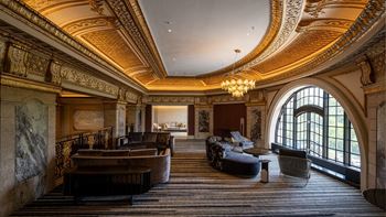 A large room with couches and chairs and a chandelier