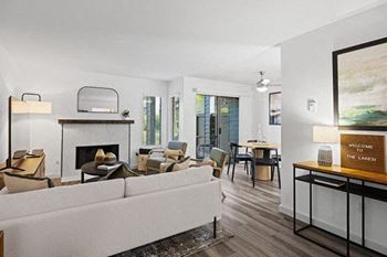 A living room with a white couch and a fireplace