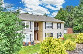 Thomasville apartment for rent - A two-story house with a brown door and a garage.