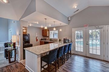Greensboro apartment for rent - a kitchen with a long counter top and a door to a porch