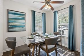 Winston-Salem apartment for rent - A dining room with a glass table and chairs.