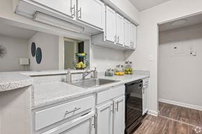Winston-Salem apartment for rent - A kitchen with white cabinets and a marble countertop.