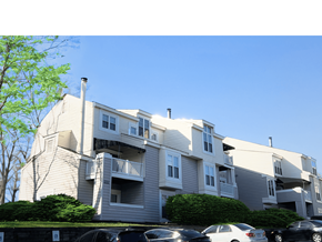 Charlotte apartment for rent - a large apartment building with cars parked in front of it