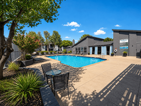 Lawton apartment for rent - A pool area with a table and chairs.