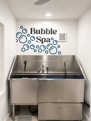 Lawton apartment for rent - A stainless steel double sink kitchen with a Bubble Spa sign on the wall.