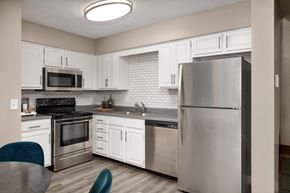Blue Springs townhouse for rent - a kitchen with stainless steel appliances and white cabinets