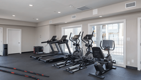 Yuma apartment for rent - A spacious gym with treadmills, elliptical machines, and other exercise equipment.