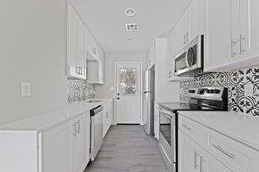 Phoenix apartment for rent - a white kitchen with white cabinets and white appliances