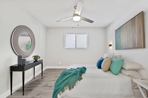 Phoenix apartment for rent - a bedroom with a large bed and a ceiling fan