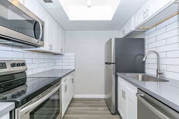 Mesa apartment for rent - a kitchen with stainless steel appliances and white cabinets