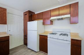 Phoenix apartment for rent - a kitchen with white appliances and wooden cabinets