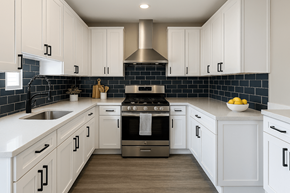 Phoenix apartment for rent - A kitchen with white cabinets and a black backsplash.