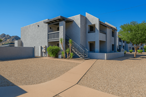 Phoenix apartment for rent - A modern house with a grey exterior and a gravel driveway.
