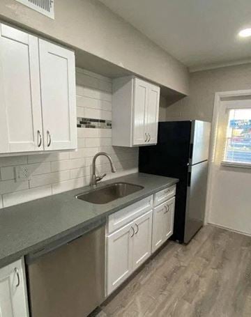 Phoenix apartment for rent - a kitchen with white cabinets and a sink and a refrigerator