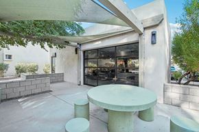 Scottsdale apartment for rent - A white table and two stools are in front of a glass door. at The Viridian, Scottsdale, AZ