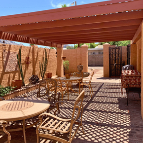 Phoenix apartment for rent - a patio with tables and chairs under a red awning