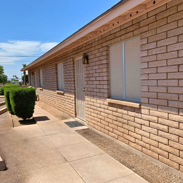 Phoenix apartment for rent - the side of a brick building with a sidewalk in front of it