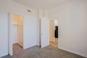 Yuma apartment for rent - a bedroom with white walls and doors and a carpeted floor