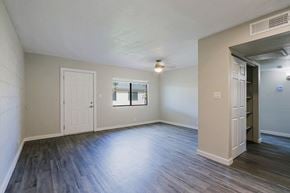 Phoenix apartment for rent - A room with a white door, a window, and a wooden floor.