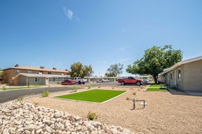 Phoenix apartment for rent - a parking lot with cars in front of a building