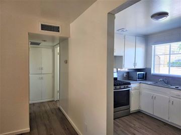 Scottsdale apartment for rent - a kitchen with white cabinets and a stove and a window