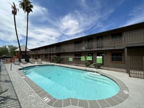 Phoenix apartment for rent - A swimming pool in a resort with a clear blue sky.