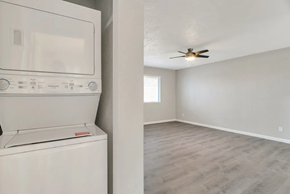 Phoenix apartment for rent - a laundry room with a washer and dryer and a ceiling fan
